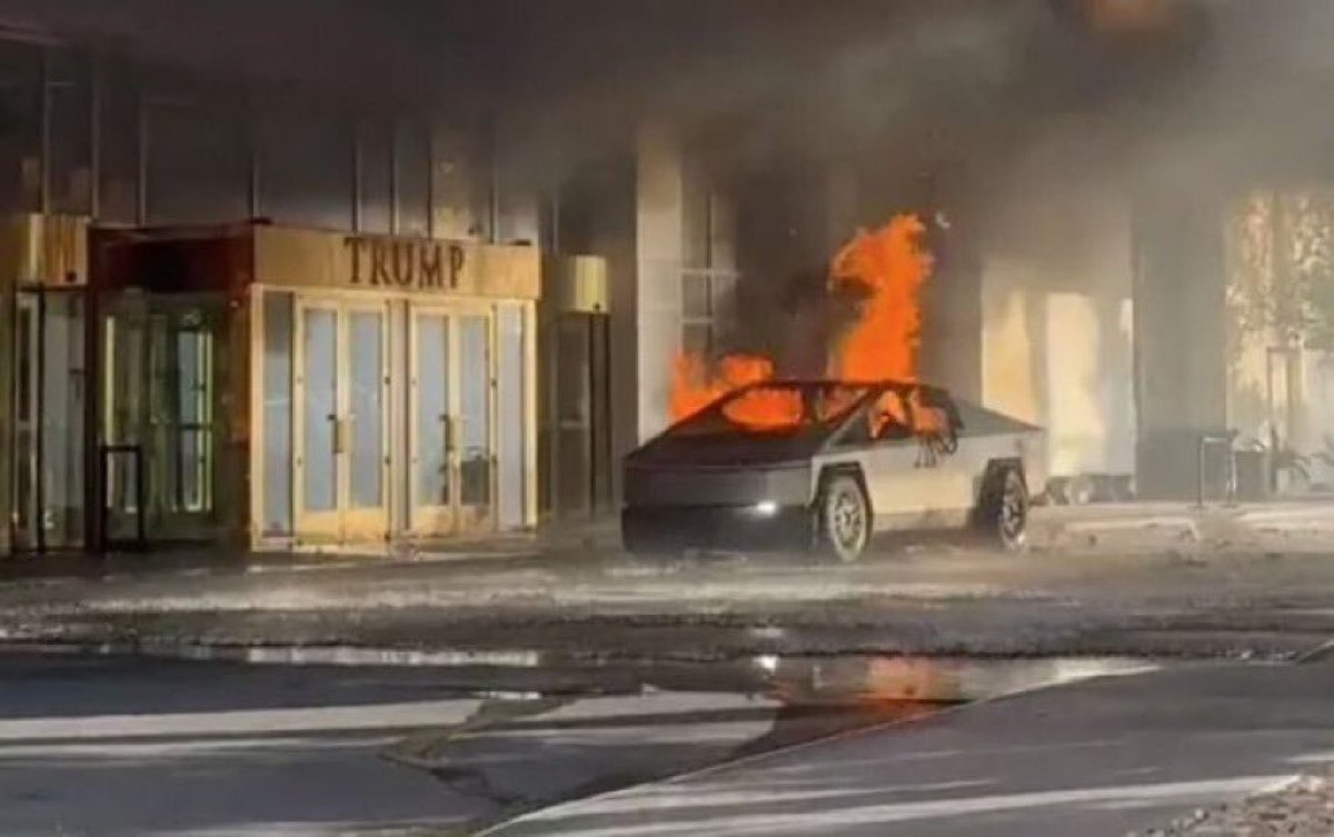 The Cybertruck in the immediate moments after the explosion, with the cabin burning but the headlights on.